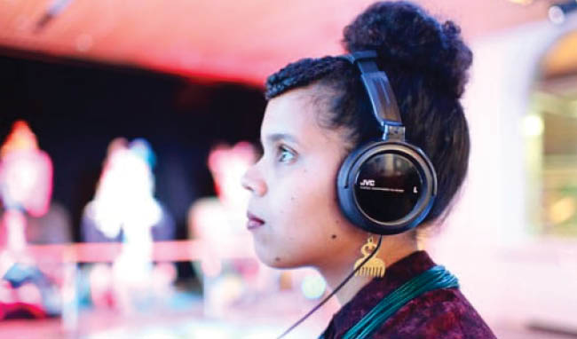 Girl wearing a headphone staring