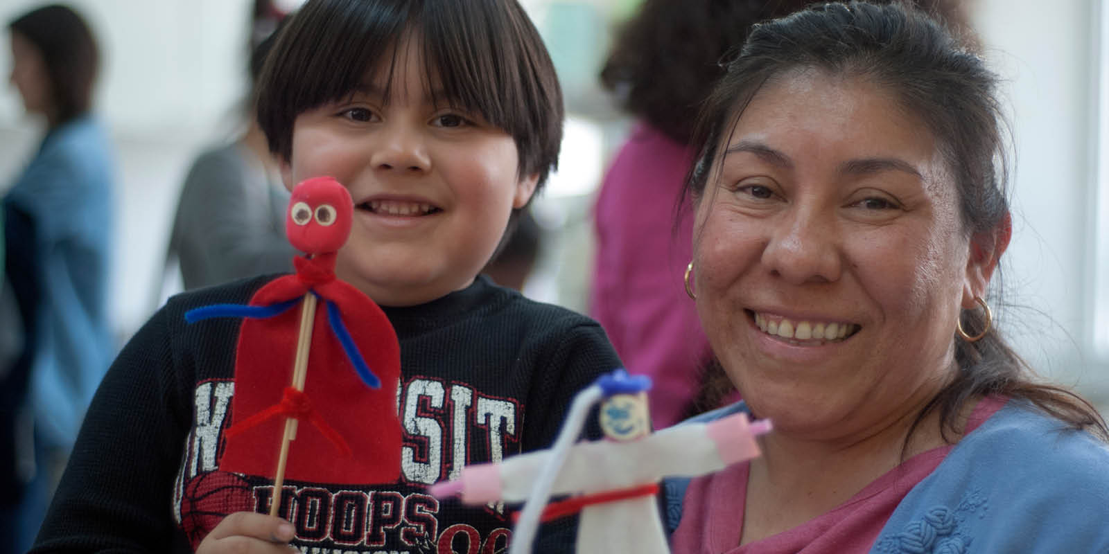 A woman and a child holding a puppet