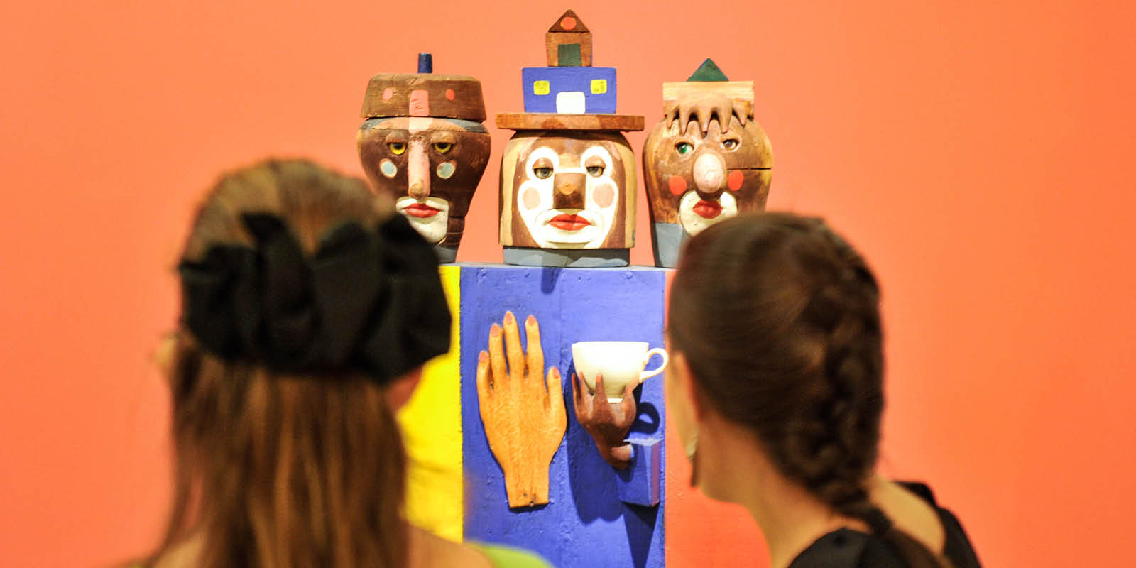 Young girls looking at art exhibition