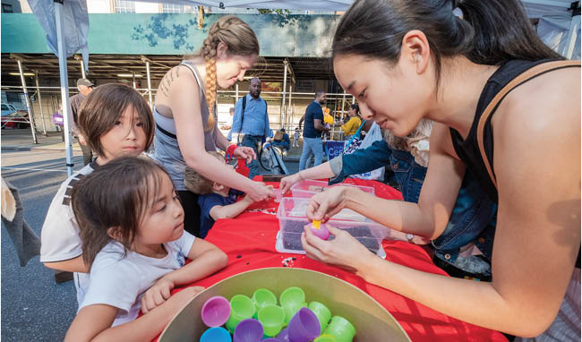 Children and volunteers enjoying creative activities outdoors