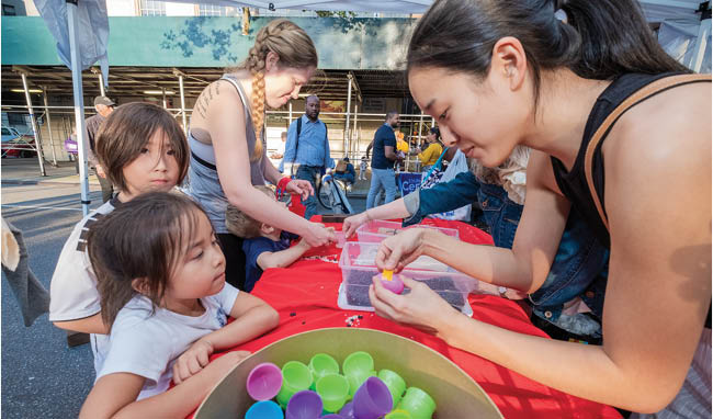 Children and volunteers enjoying creative activities outdoors