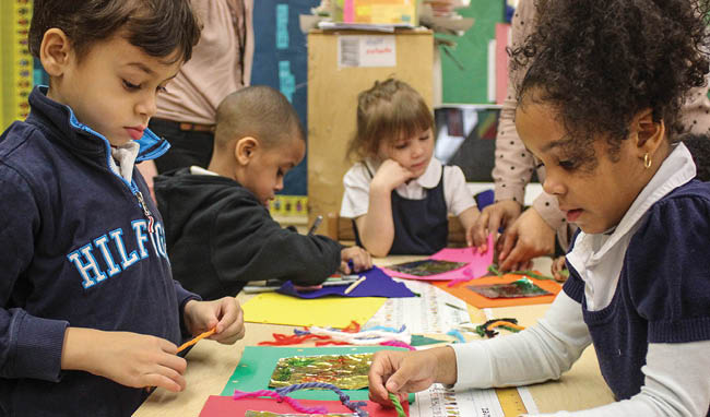 a group of children working on art